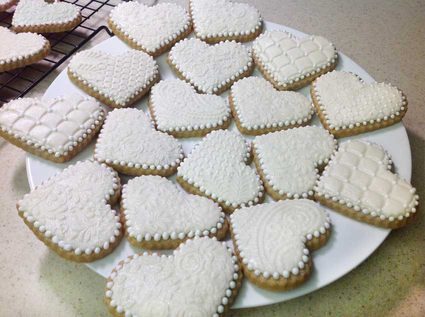 Plate of all-white heart-shaped cookies